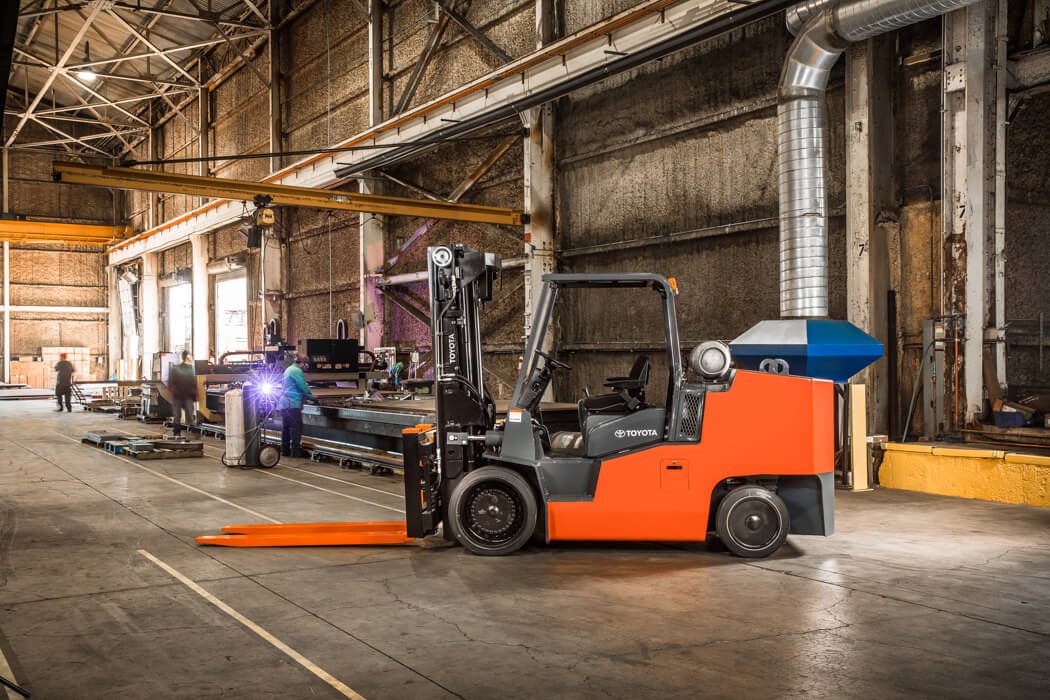 IC Cushion Toyota forklift parked in warehouse from side angle