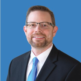A professional headshot of Ryan Delaney