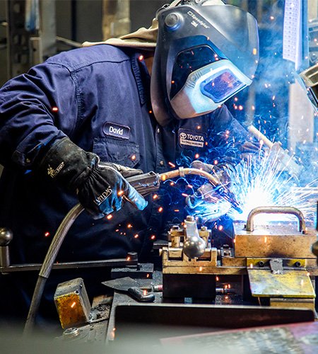 Toyota welder working on machinery 